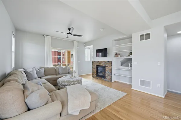 a living room with furniture a fireplace and a flat screen tv