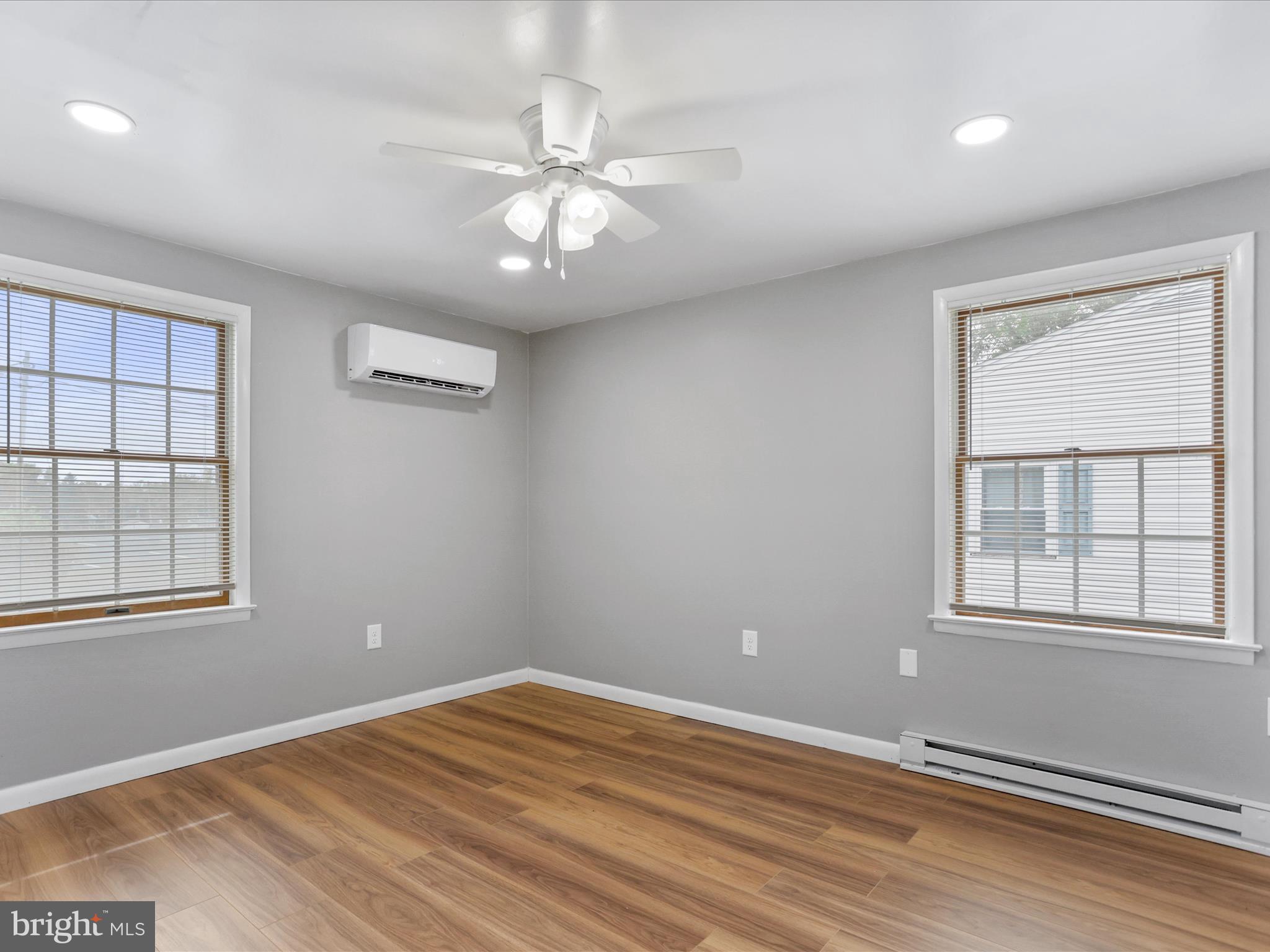 12343 Big Spring Road Clear Spring, MD 21722 - Photo 24 of 34 an empty room with wooden floor chandelier fan and windows