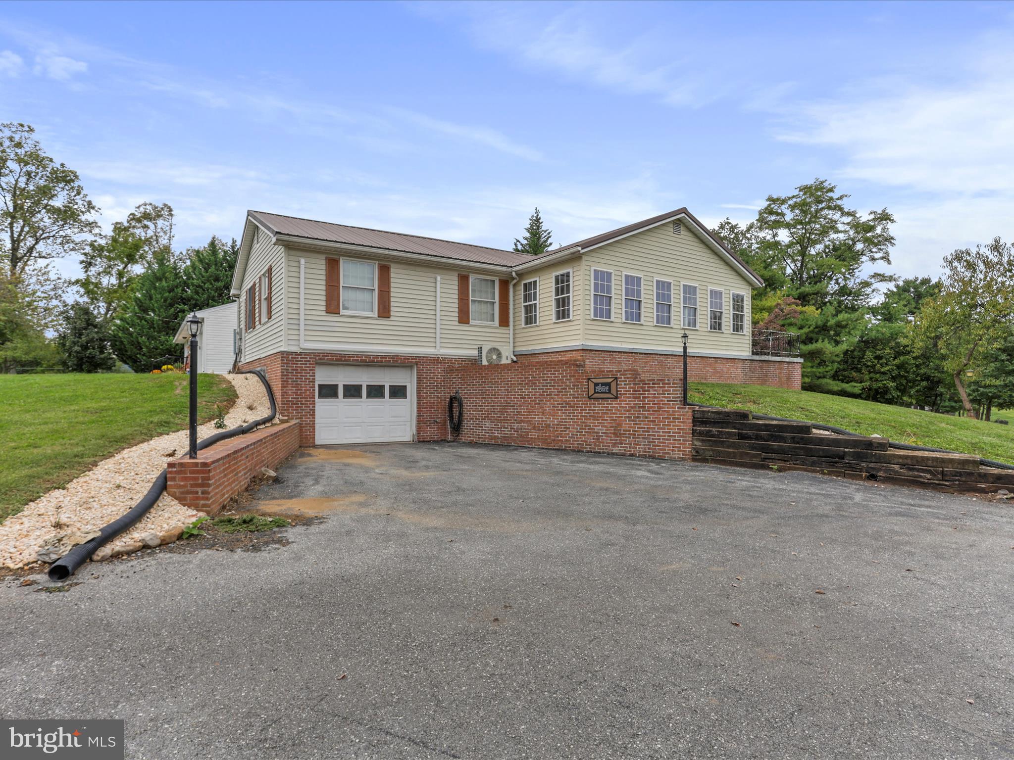 12343 Big Spring Road Clear Spring, MD 21722 - Photo 5 of 34 a front view of a house with a yard and garage
