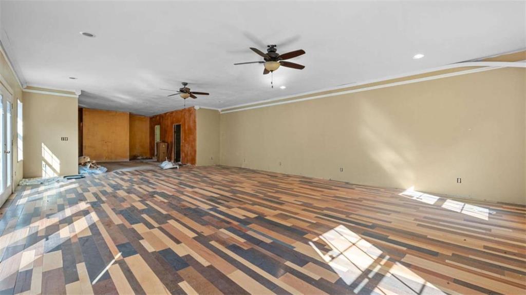 733 Unity Church Road Summerville, GA 30747 - Photo 60 of 75 a view of a livingroom with wooden floor and a ceiling fan