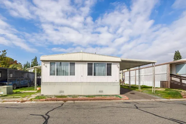 a front view of a house with a garden and pathway