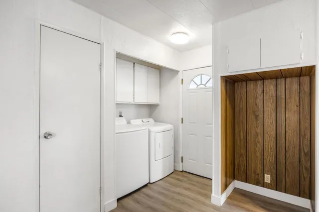 a view of a hallway to closet with wooden floor