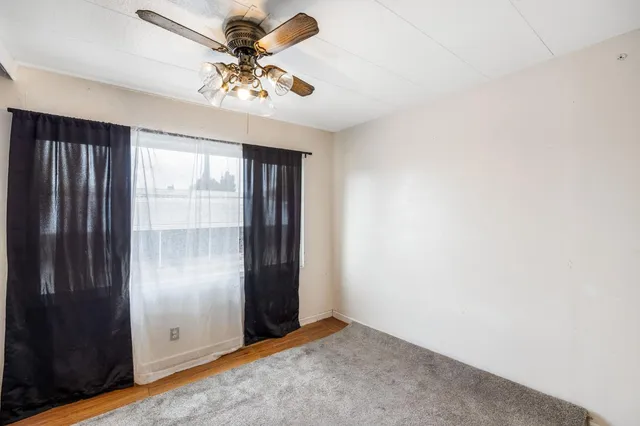 an empty room with windows and closet