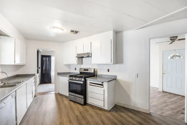a kitchen with a stove a sink and a refrigerator