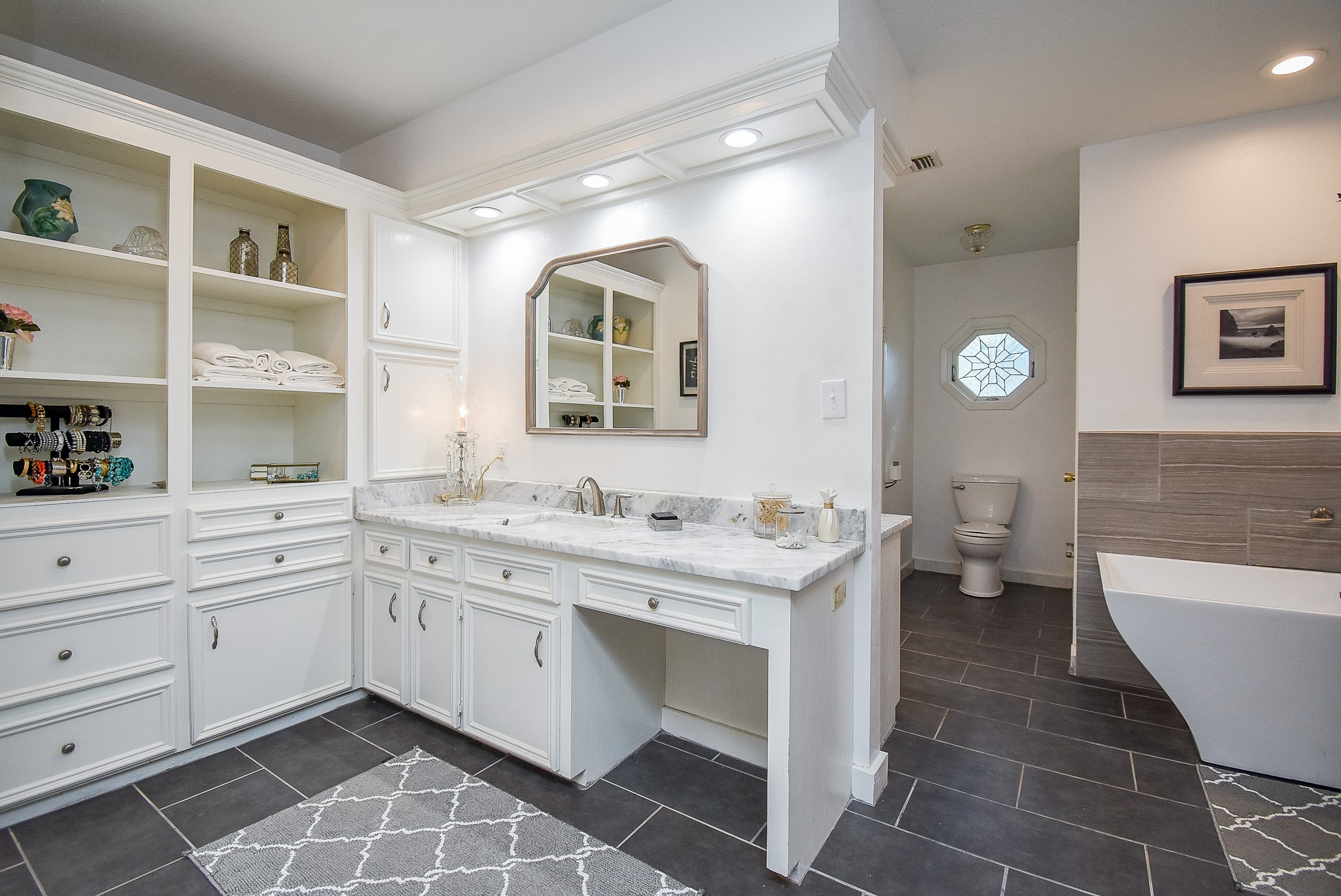 2146 17th Street Hempstead, TX 77445 - Photo 31 of 50 a spacious bathroom with a double vanity sink a mirror and a toilet