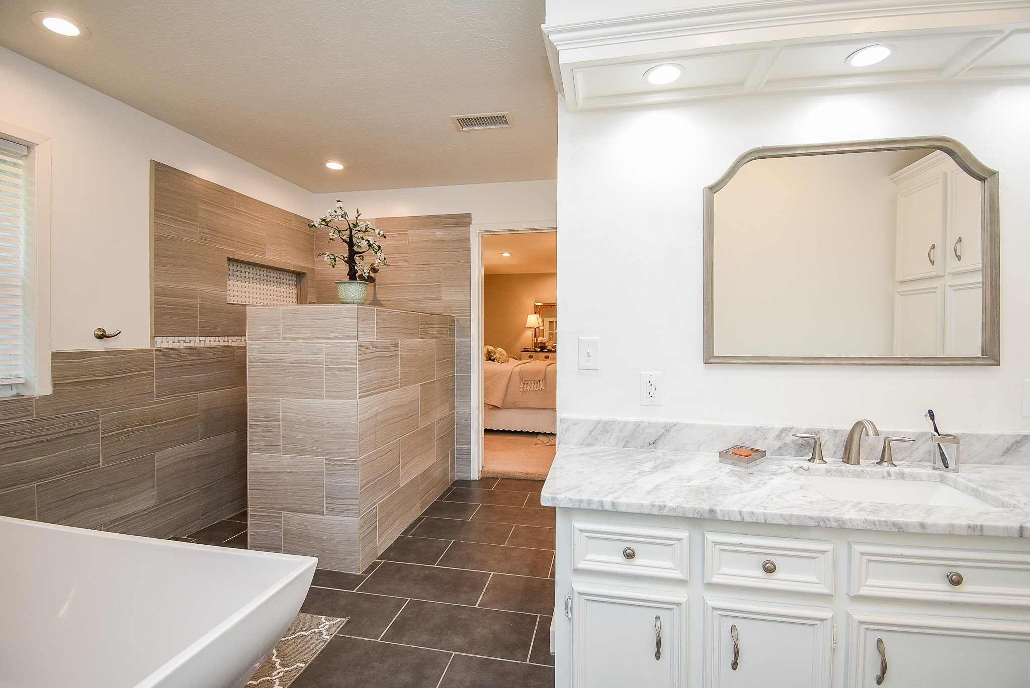 2146 17th Street Hempstead, TX 77445 - Photo 33 of 50 a bathroom with a granite countertop sink a mirror and shower