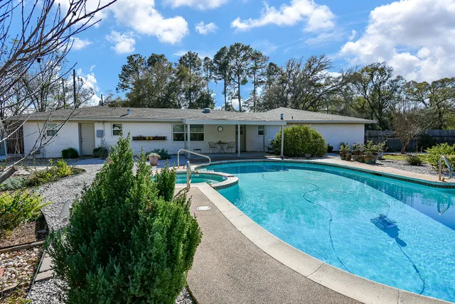a view of a swimming pool with a yard