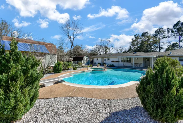 a front view of house with outdoor space and swimming pool
