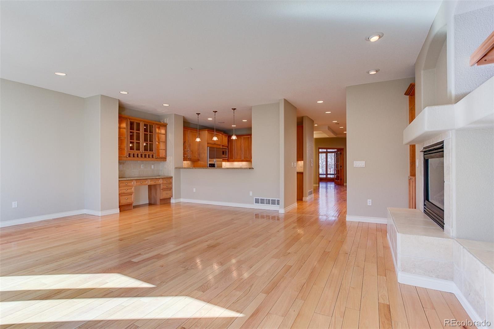 338 St Paul Street Denver, CO 80206 - Photo 13 of 35 a view of a big room with wooden floor and a kitchen