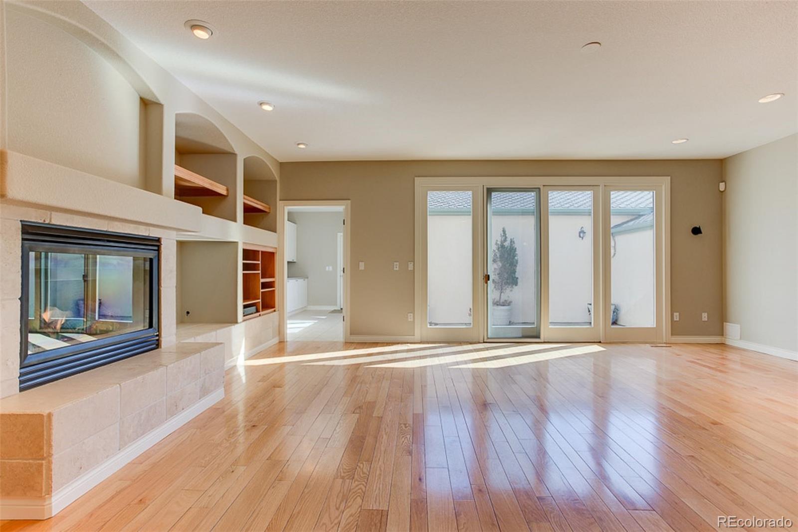 338 St Paul Street Denver, CO 80206 - Photo 14 of 35 a view of an empty room with wooden floor and a window