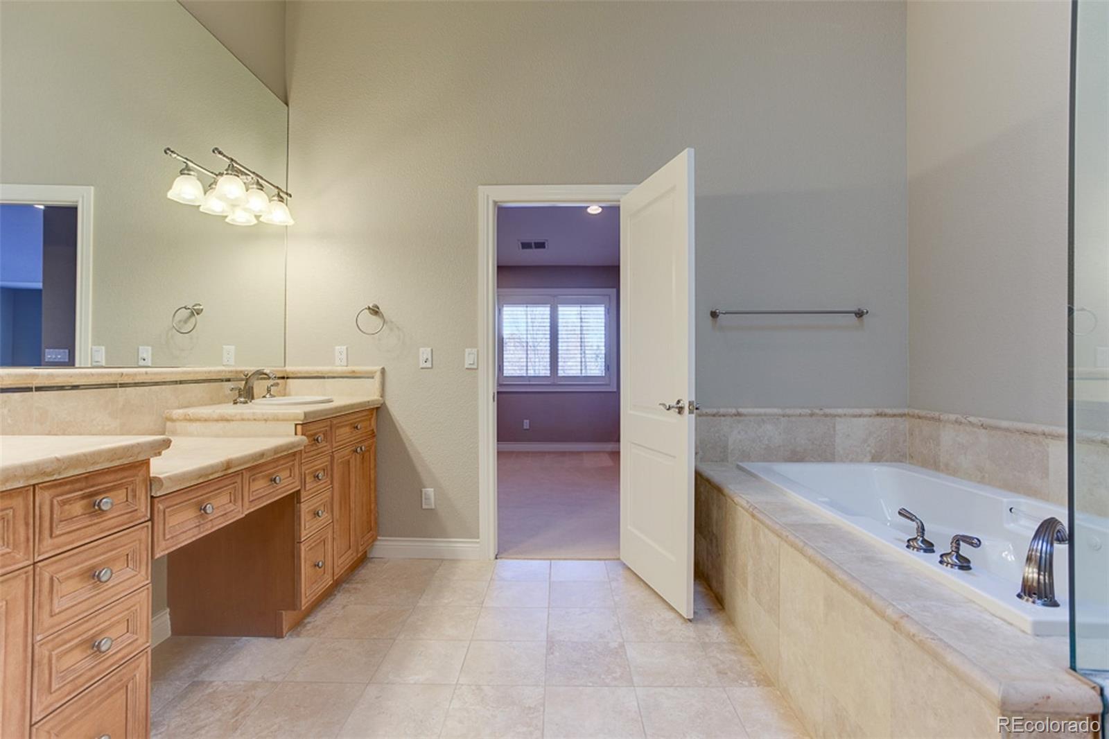 338 St Paul Street Denver, CO 80206 - Photo 18 of 35 a bathroom with a bathtub a sink and a mirror
