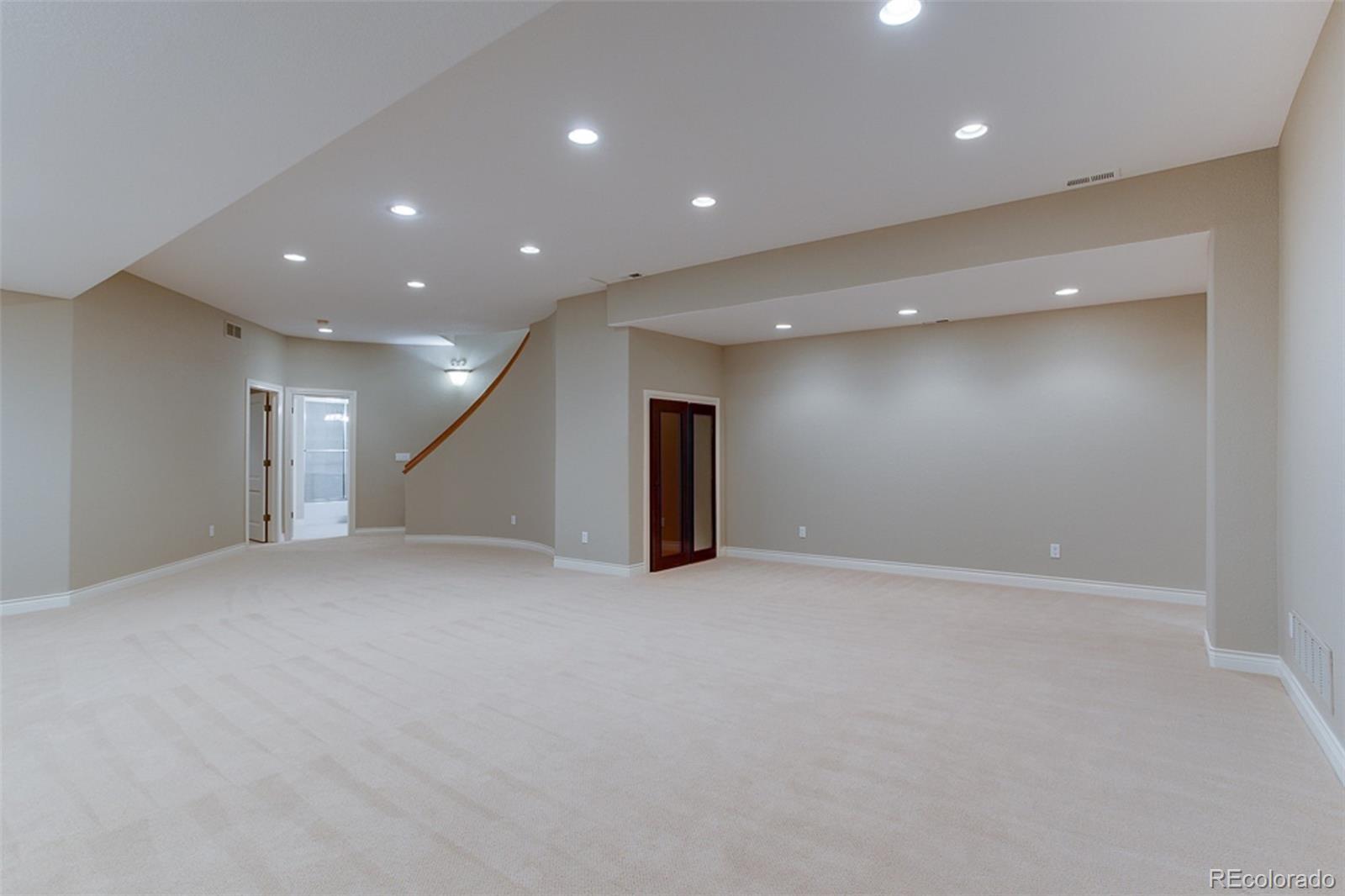 338 St Paul Street Denver, CO 80206 - Photo 27 of 35 an empty room with a projector and stairs