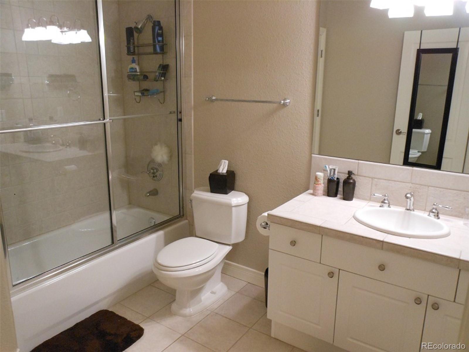 338 St Paul Street Denver, CO 80206 - Photo 31 of 35 a bathroom with a sink a toilet and shower