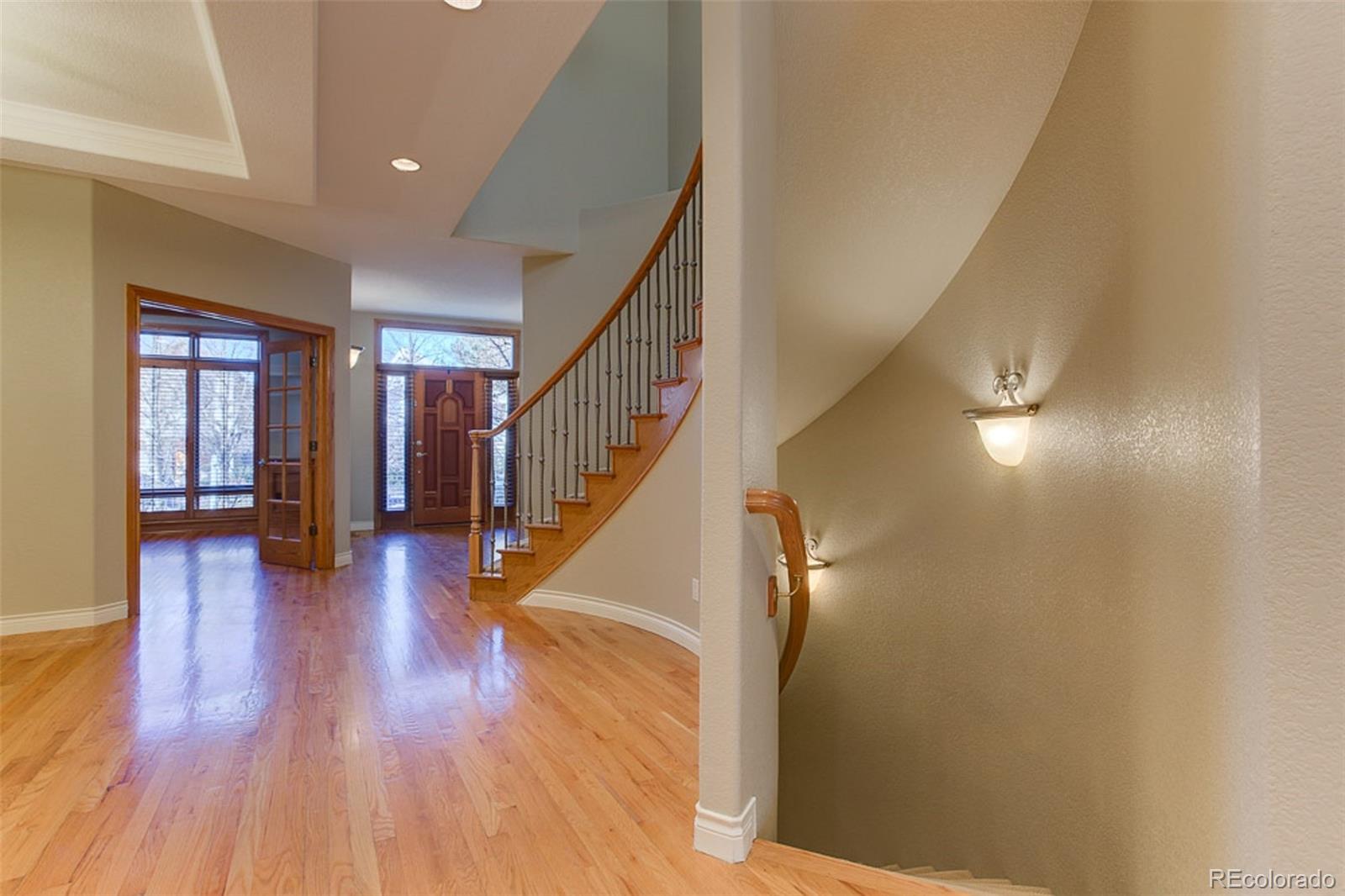 338 St Paul Street Denver, CO 80206 - Photo 4 of 35 a view of a hallway with wooden floor and staircase