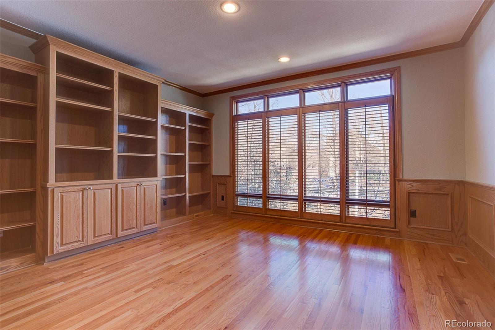 338 St Paul Street Denver, CO 80206 - Photo 7 of 35 a view of an empty room with wooden floor and a window