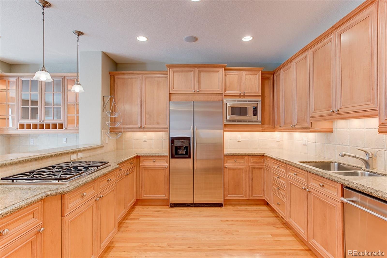 338 St Paul Street Denver, CO 80206 - Photo 8 of 35 a kitchen with stainless steel appliances granite countertop a stove a sink and a refrigerator