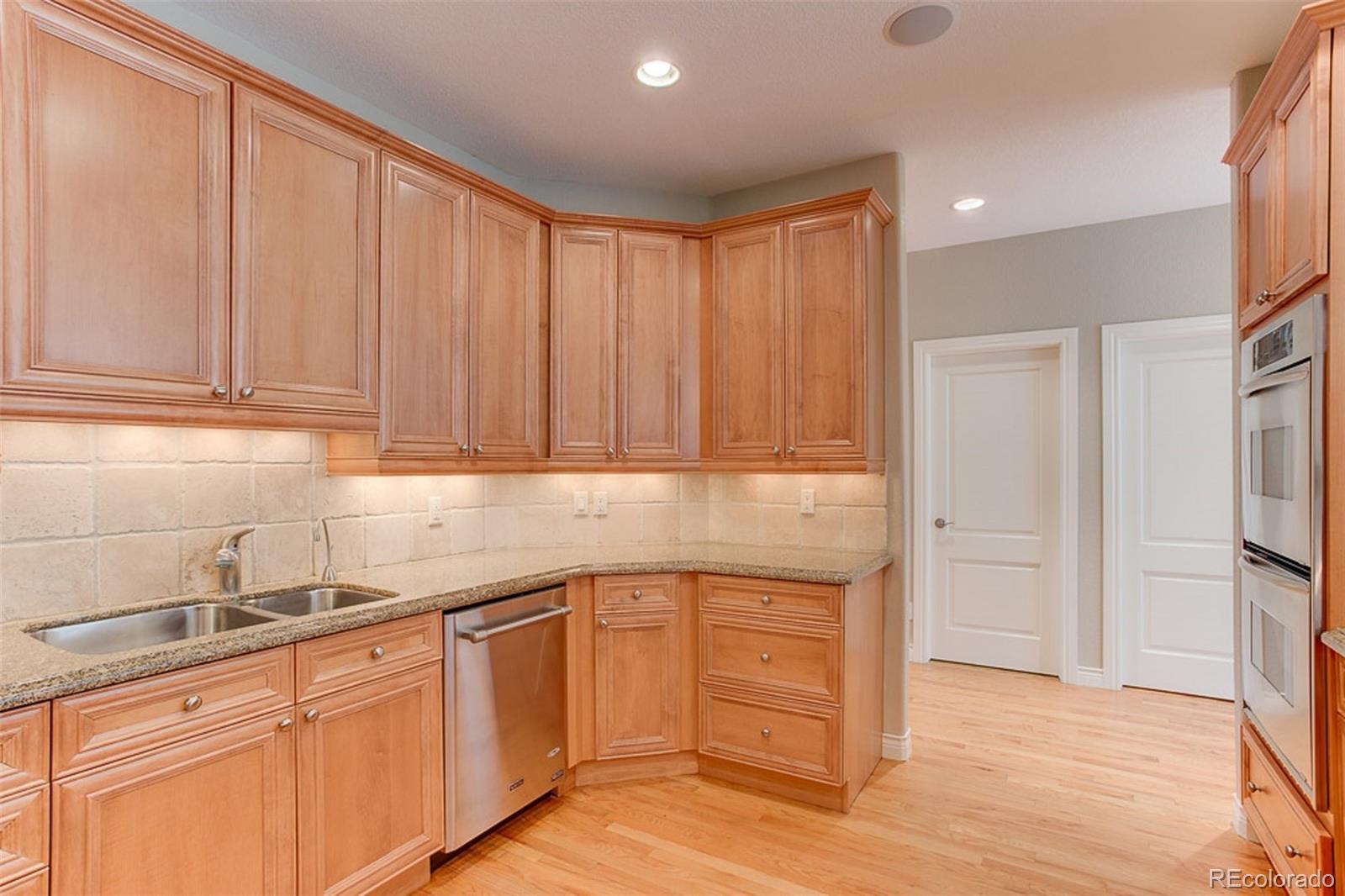 338 St Paul Street Denver, CO 80206 - Photo 10 of 35 a kitchen with a sink cabinets and stainless steel appliances