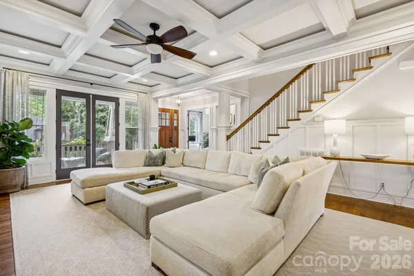 a living room with furniture ceiling fan and a rug