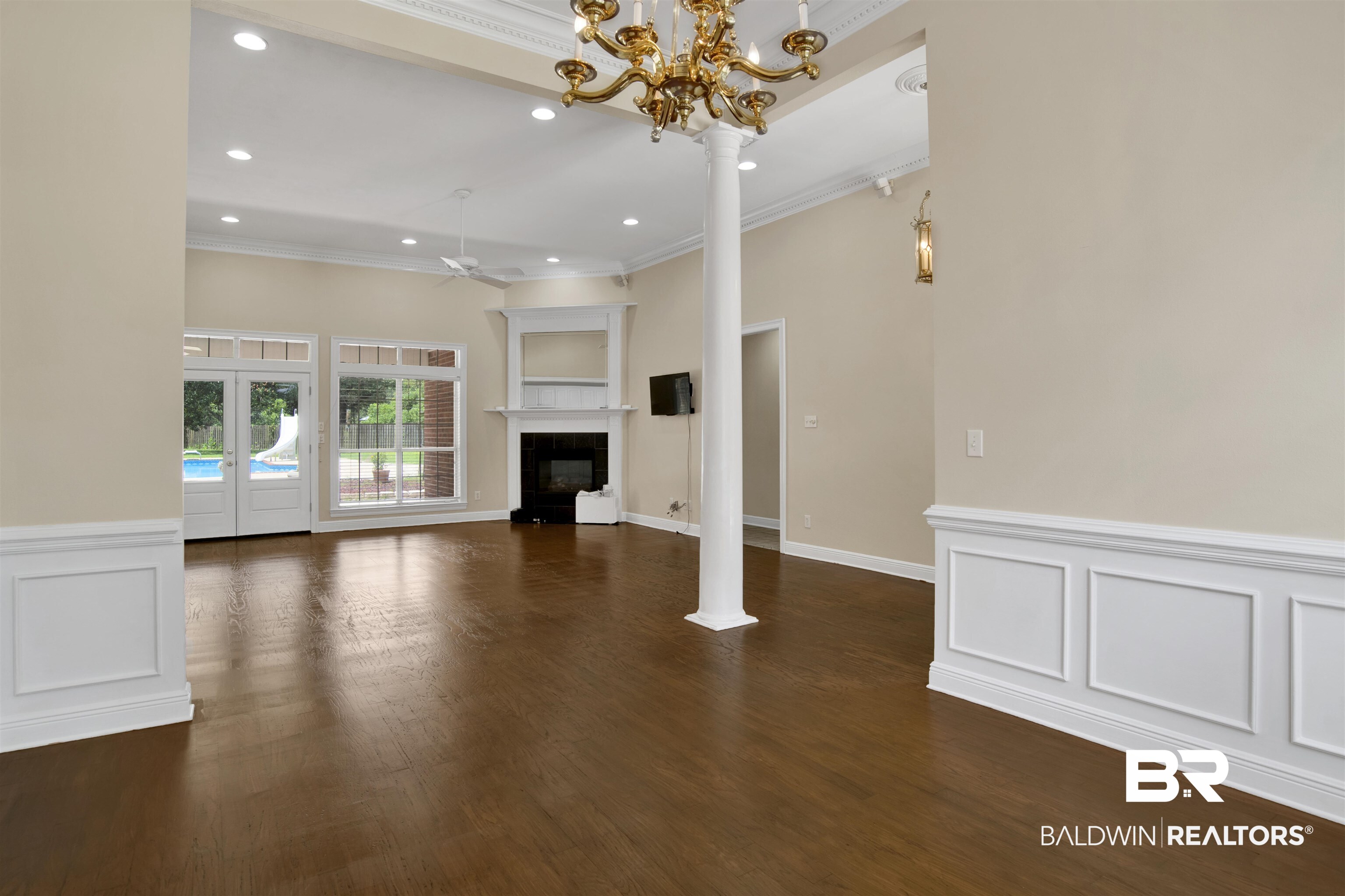 8847 Dawes Lake Road South Mobile, AL 36619 - Photo 35 of 47 Spacious interior with dark wood-finish flooring, wainscoting, and a fireplace with mantel