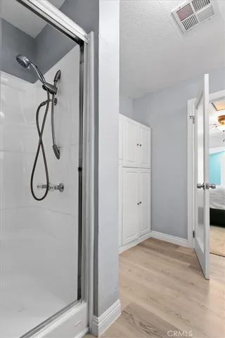 a bedroom with a bed dresser and a window