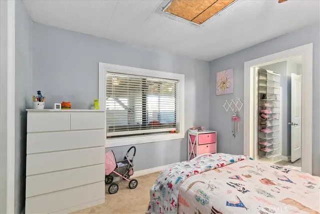 a spacious bathroom with a sink a toilet and a mirror