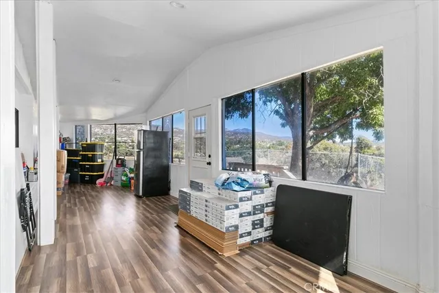 a living room with furniture and large windows