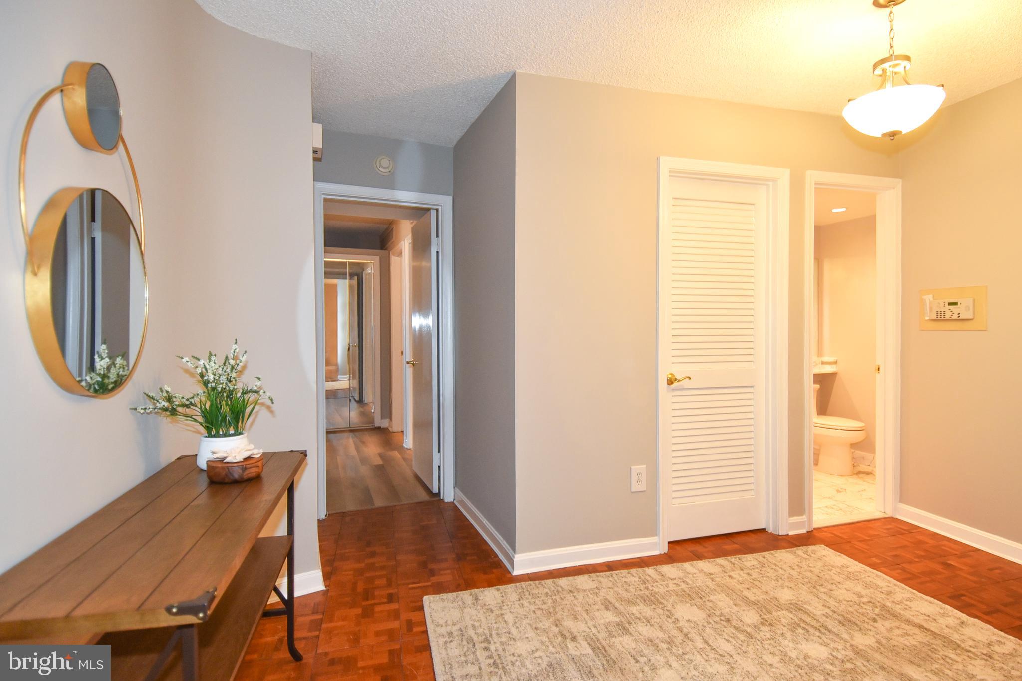 1101 South Arlington Ridge Road, Unit 305 Arlington, VA 22202 - Photo 19 of 57 Foyer to Primary Bedroom