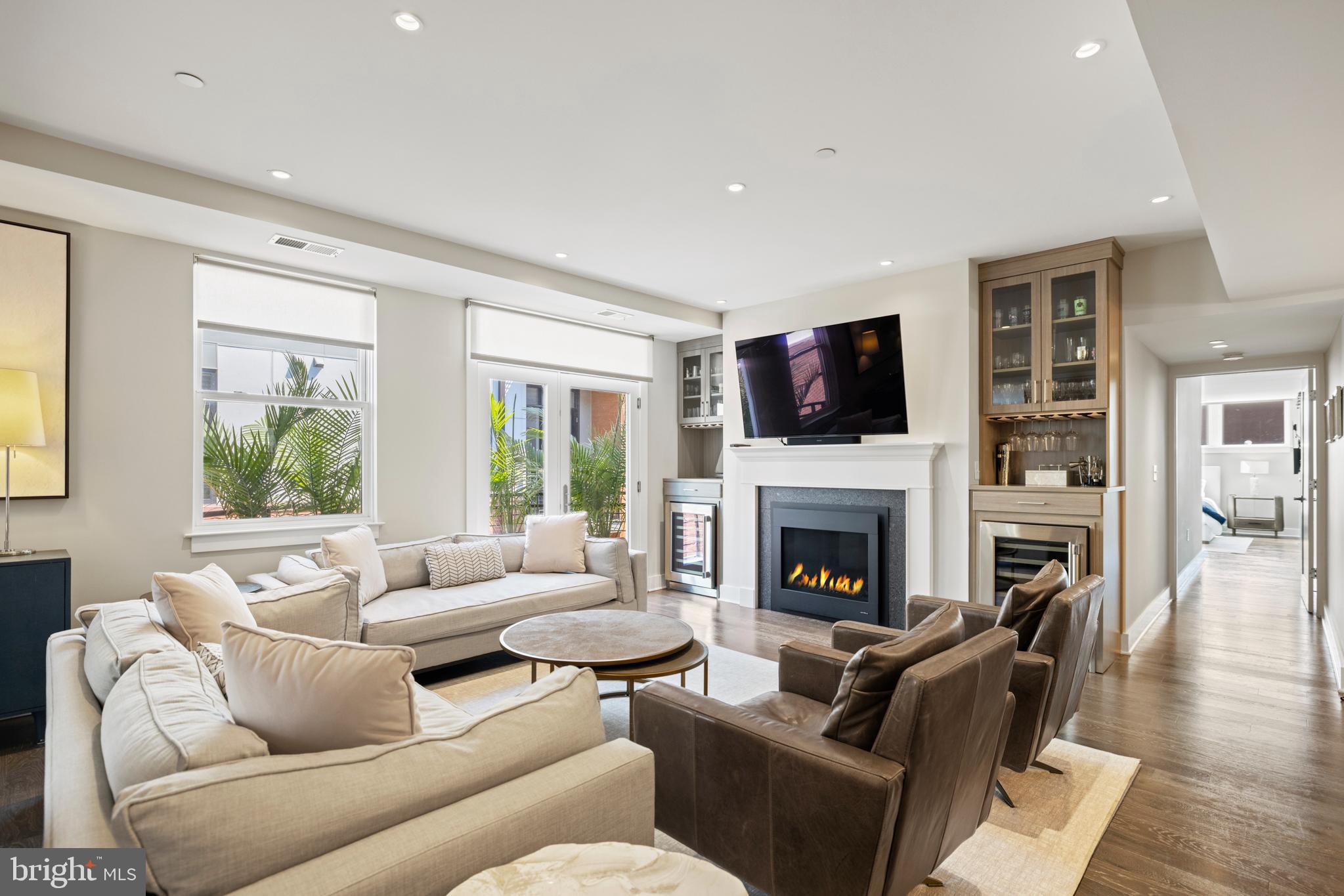 a living room with furniture flat screen tv and a fireplace