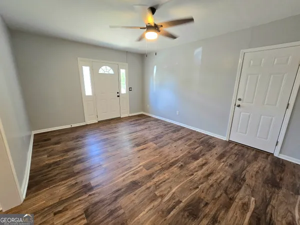 wooden floor in an empty room with a window