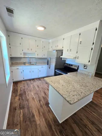 a view of kitchen with wooden floor