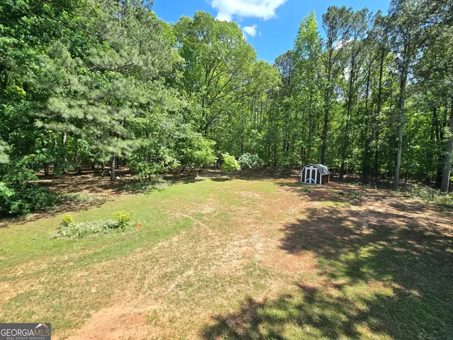a view of a yard with a table and chair