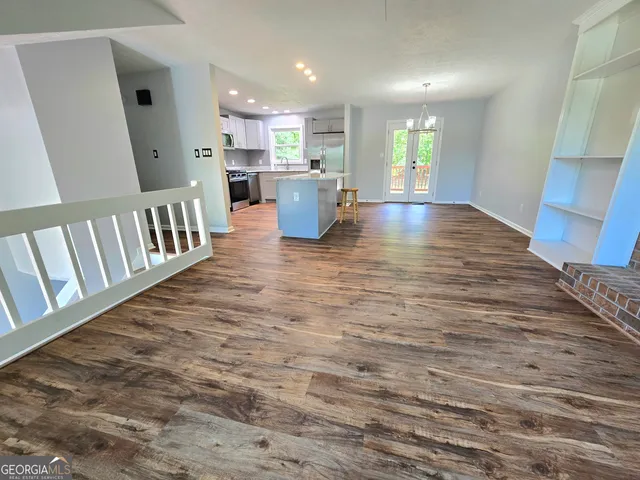 a view of kitchen and hall with wooden floor