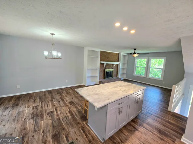 a spacious bedroom with a bed and a flat screen tv
