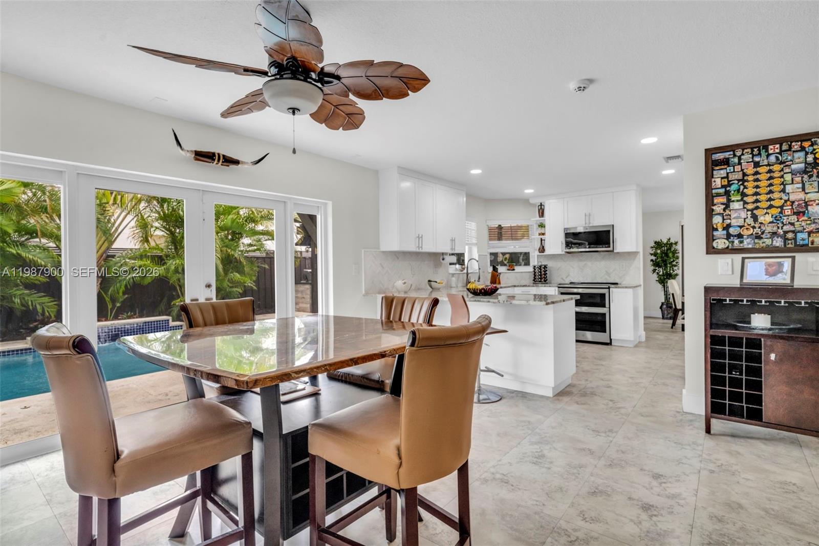 15726 Southwest 76th Terrace Miami, FL 33193 - Photo 13 of 34 a dining room with furniture a chandelier and window