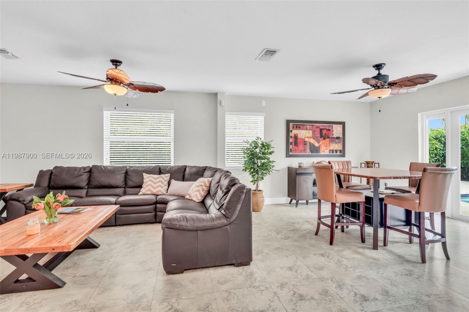 15726 Southwest 76th Terrace Miami, FL 33193 - Photo 16 of 34 a living room with furniture kitchen view and a window