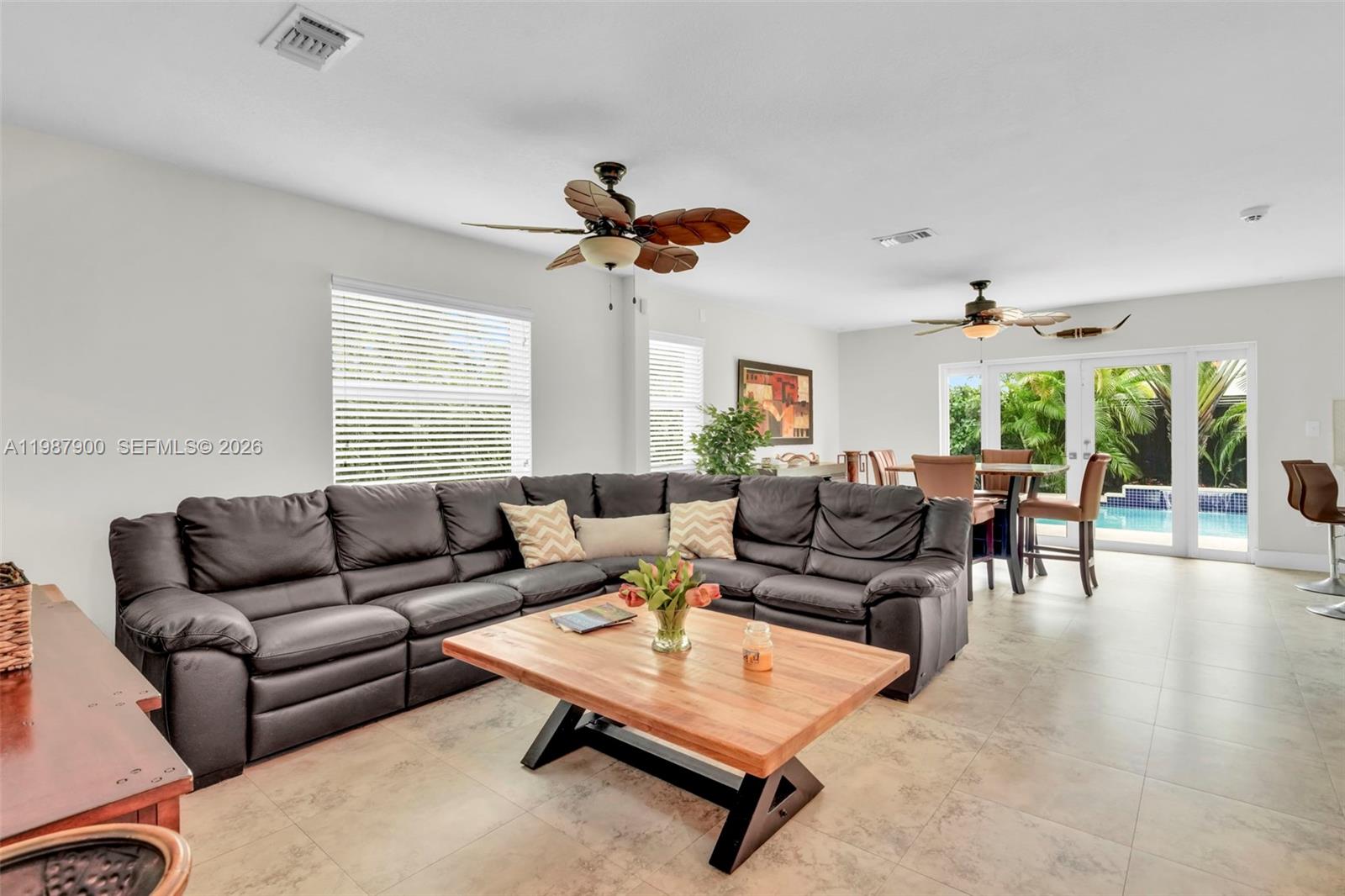 15726 Southwest 76th Terrace Miami, FL 33193 - Photo 17 of 34 a living room with furniture and a large window
