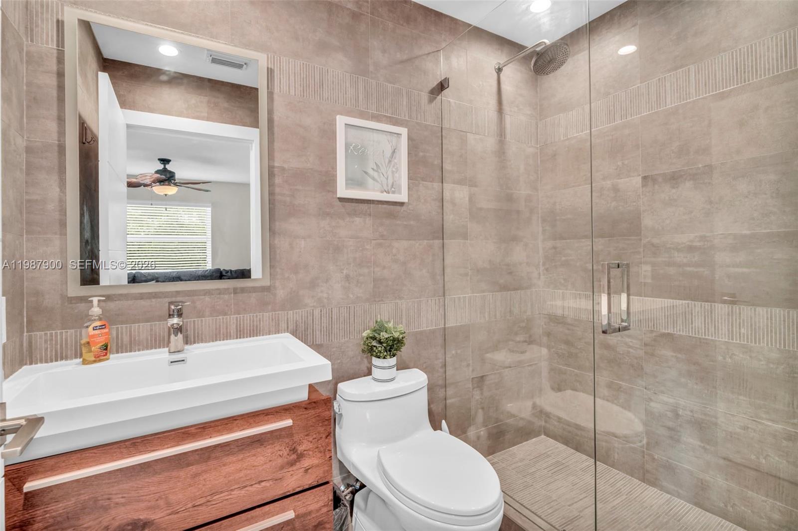 15726 Southwest 76th Terrace Miami, FL 33193 - Photo 18 of 34 a bathroom with a sink a toilet and shower