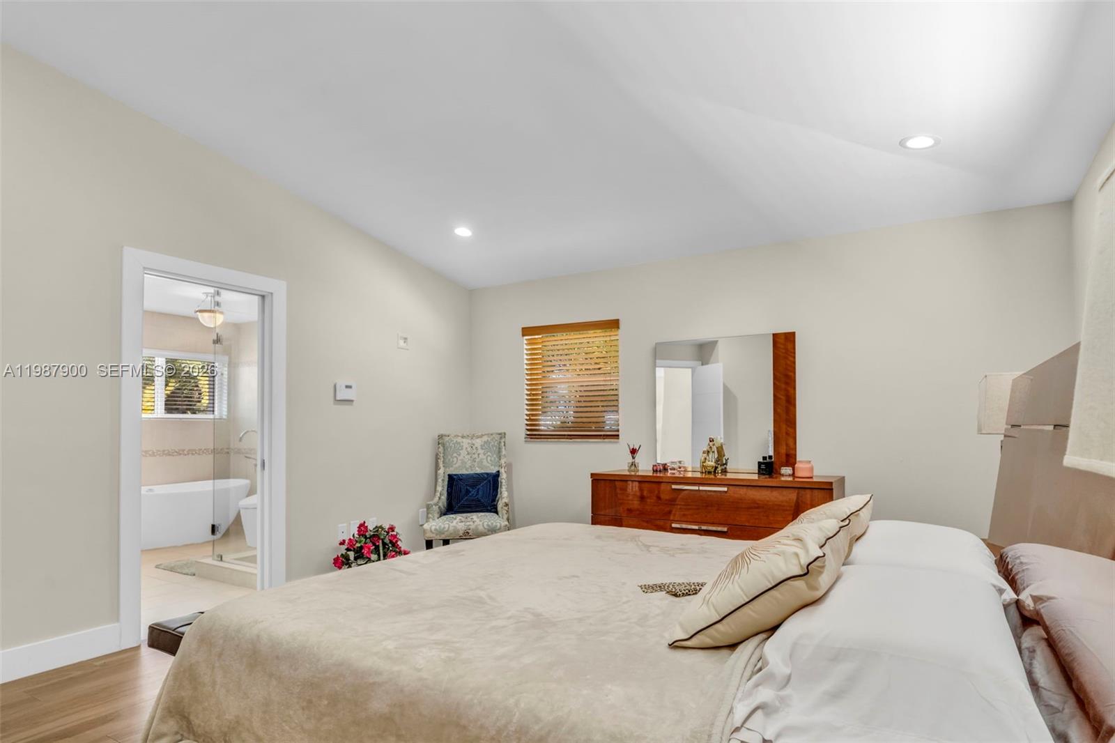 15726 Southwest 76th Terrace Miami, FL 33193 - Photo 24 of 34 a bedroom with a bed and a large mirror in it