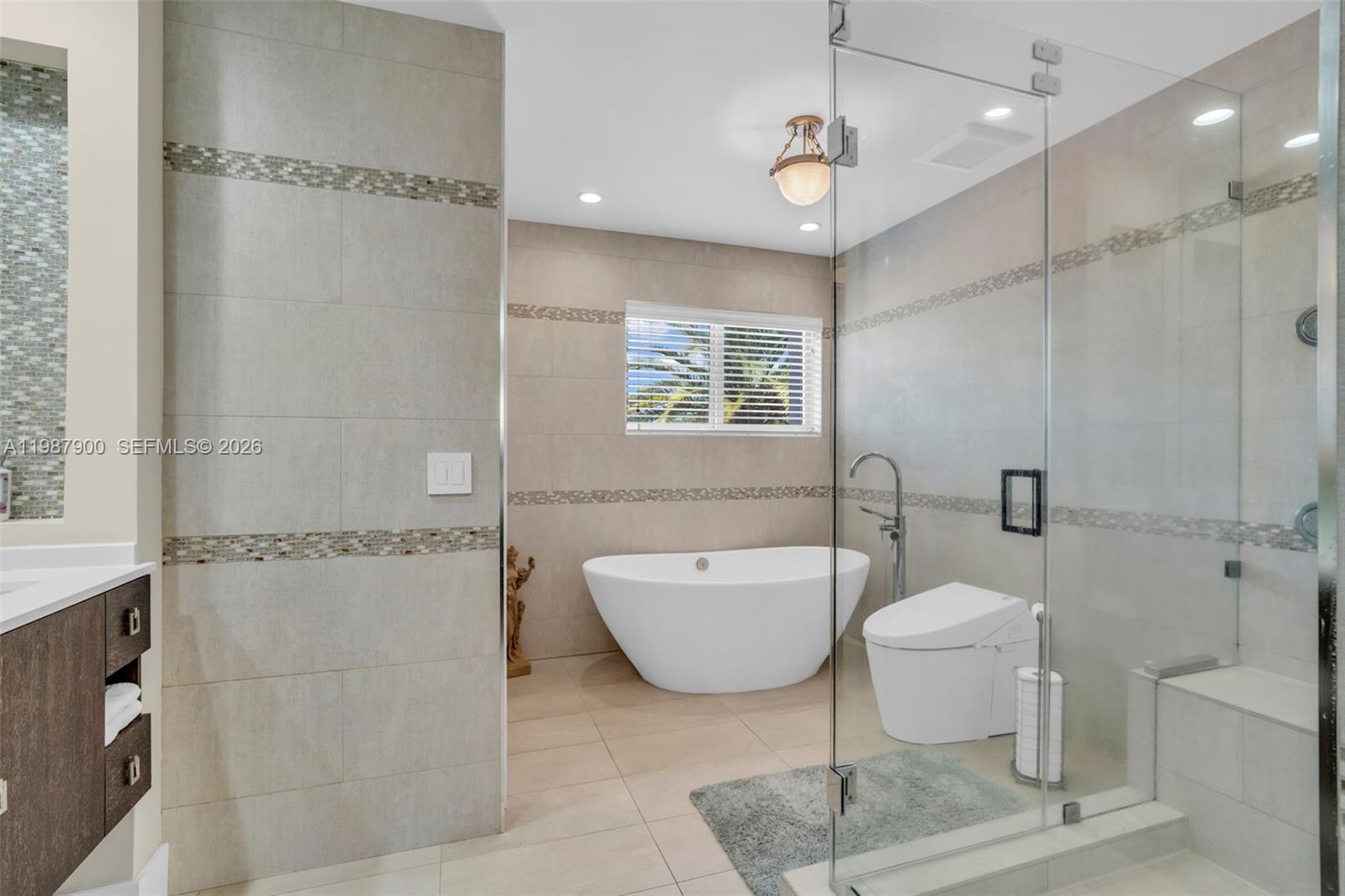 15726 Southwest 76th Terrace Miami, FL 33193 - Photo 25 of 34 a spacious bathroom with a toilet a sink and a mirror