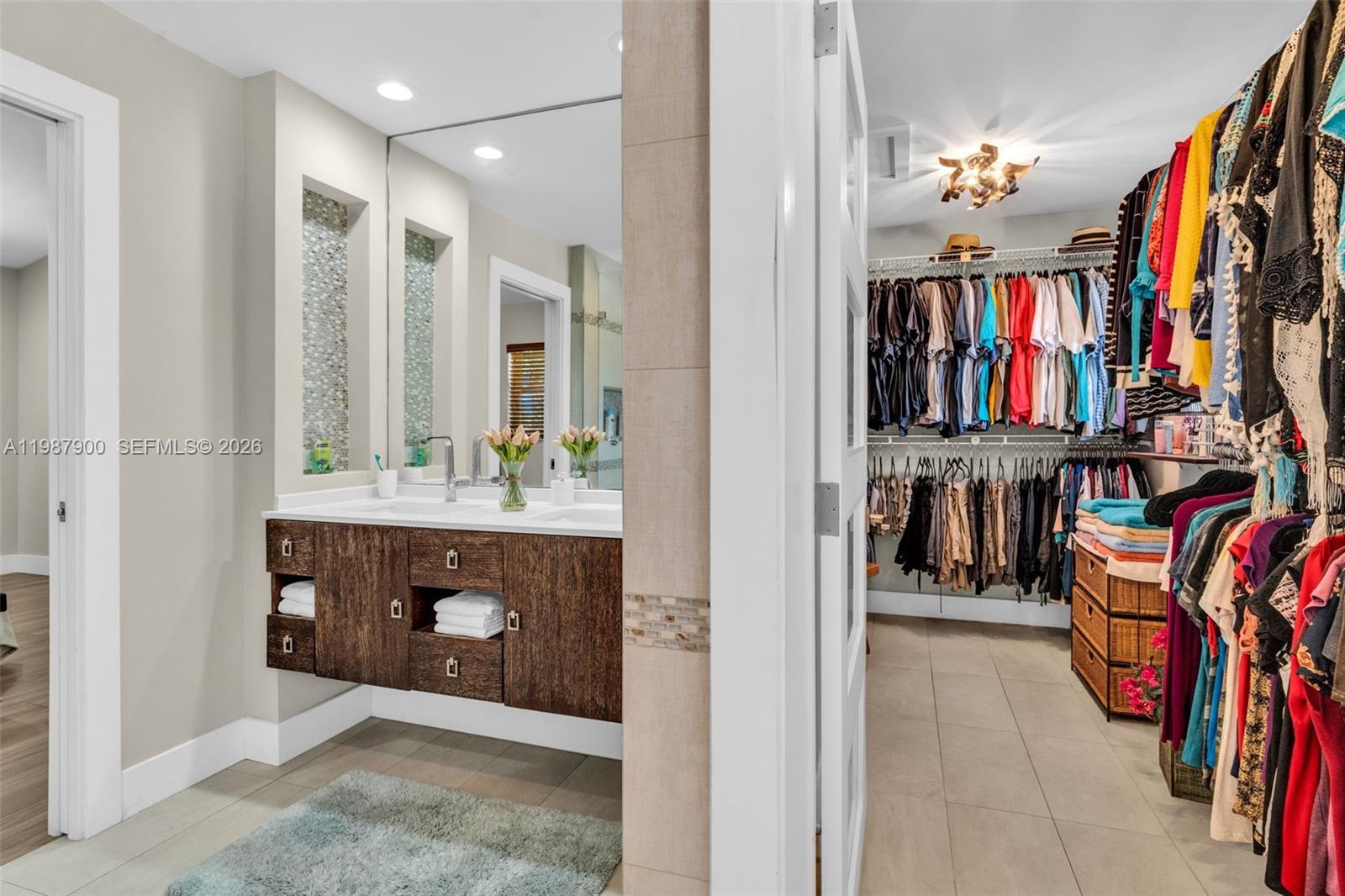 15726 Southwest 76th Terrace Miami, FL 33193 - Photo 27 of 34 a view of walk in closet with clothes and shoes
