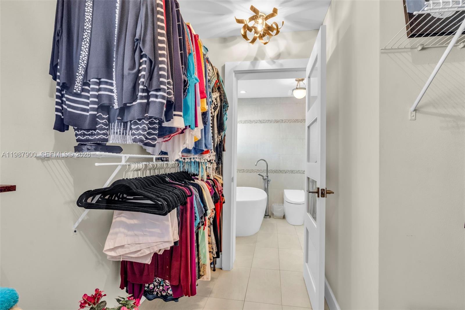 15726 Southwest 76th Terrace Miami, FL 33193 - Photo 28 of 34 a view of walk in closet with clothes and shoes