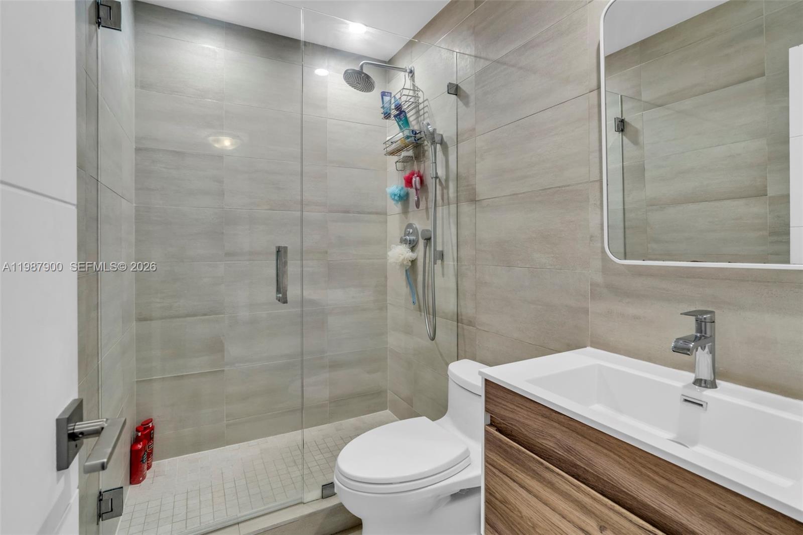 15726 Southwest 76th Terrace Miami, FL 33193 - Photo 29 of 34 a bathroom with a sink toilet and shower