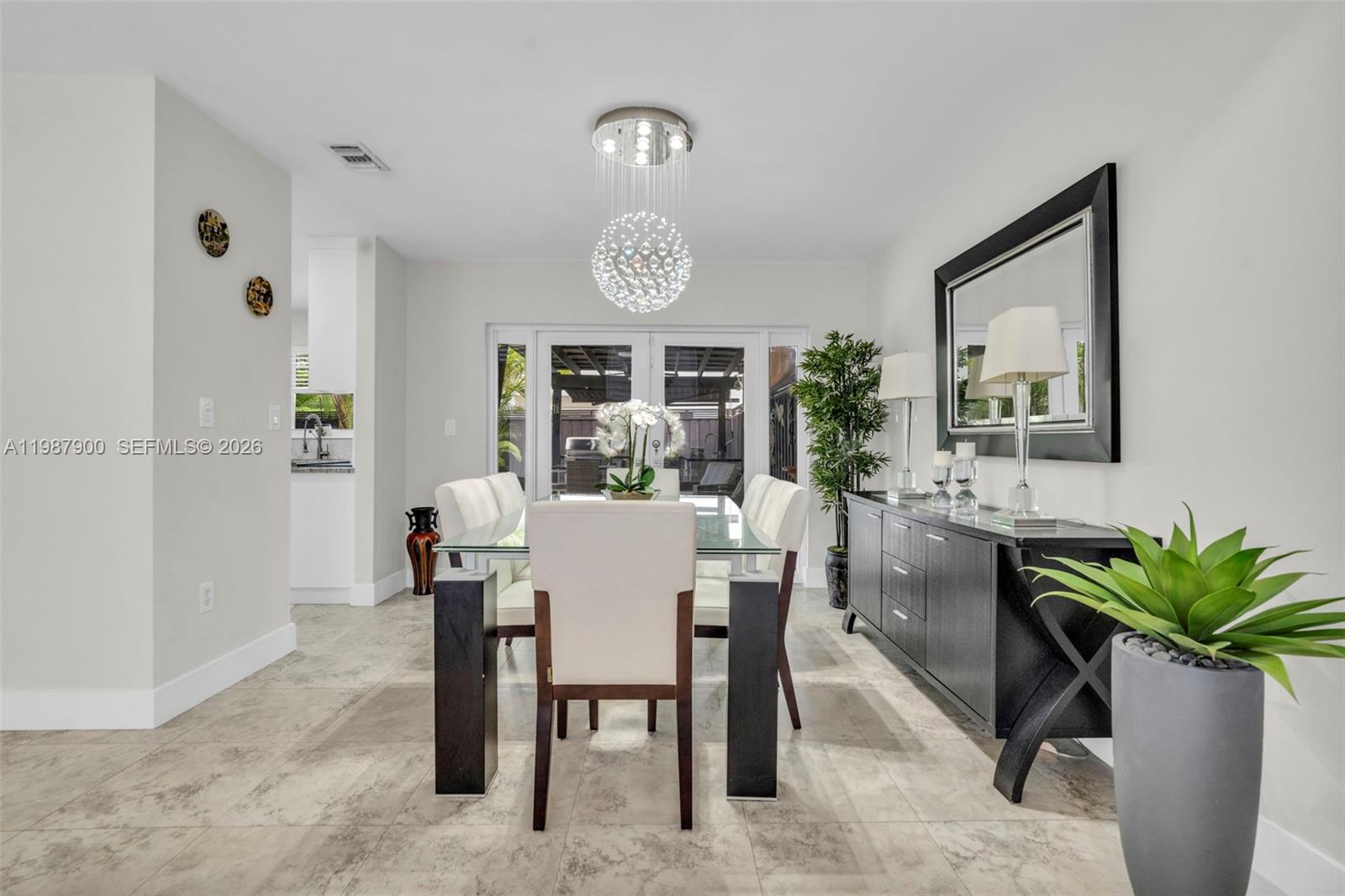 15726 Southwest 76th Terrace Miami, FL 33193 - Photo 9 of 34 a view of a dining room with furniture window and flowerpot