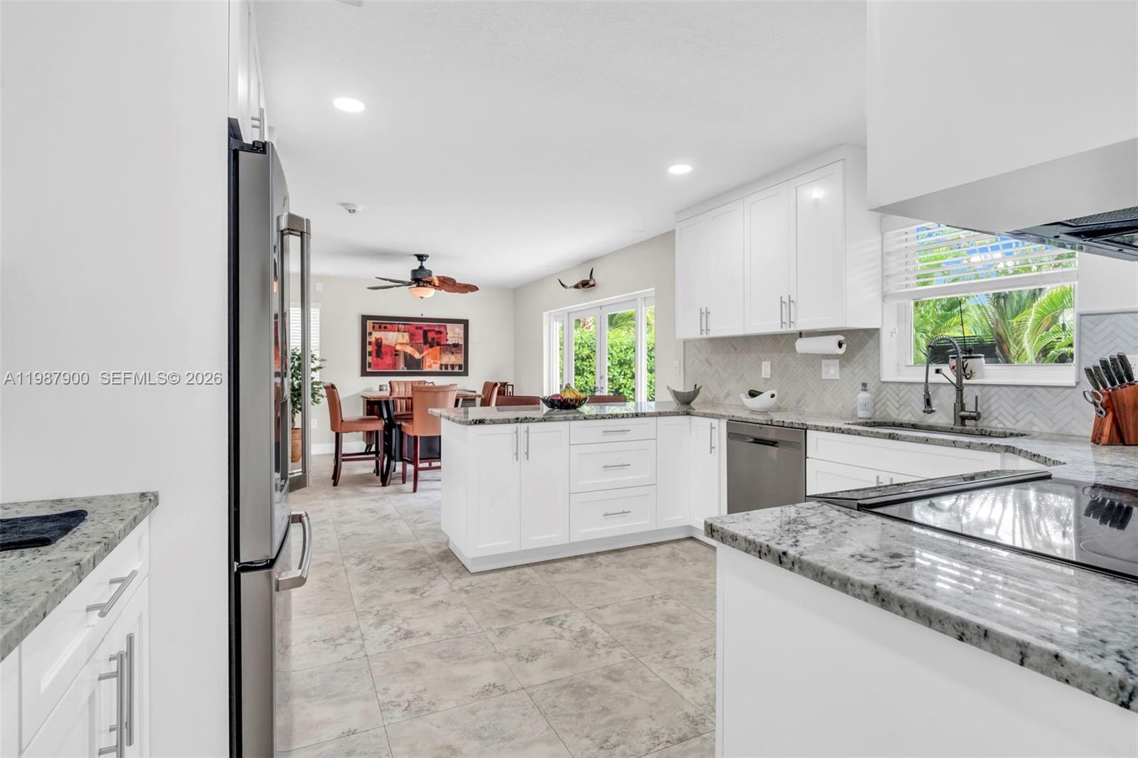 15726 Southwest 76th Terrace Miami, FL 33193 - Photo 10 of 34 a kitchen with stainless steel appliances granite countertop a sink stove and cabinets