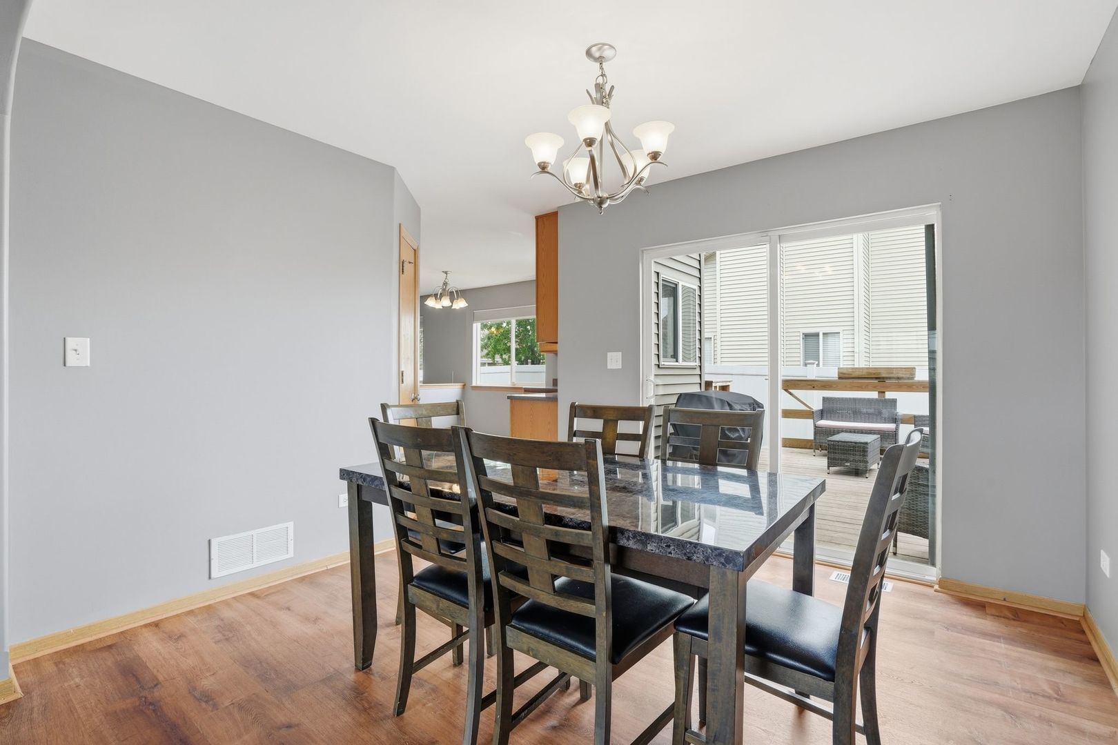 797 Kyle Court Braidwood, IL 60408 - Photo 6 of 33 a view of a dining room with furniture a chandelier and wooden floor