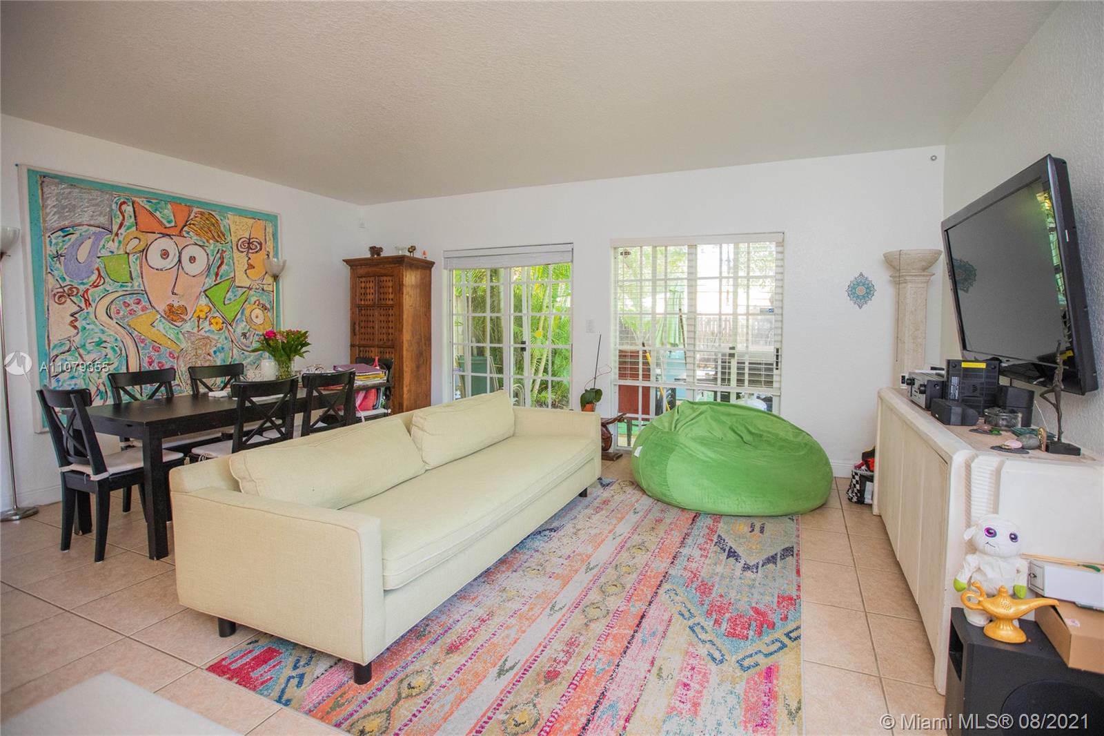 3053 Elizabeth Street, Unit 3053 Miami, FL 33133 - Photo 11 of 42 a living room with furniture and a flat screen tv