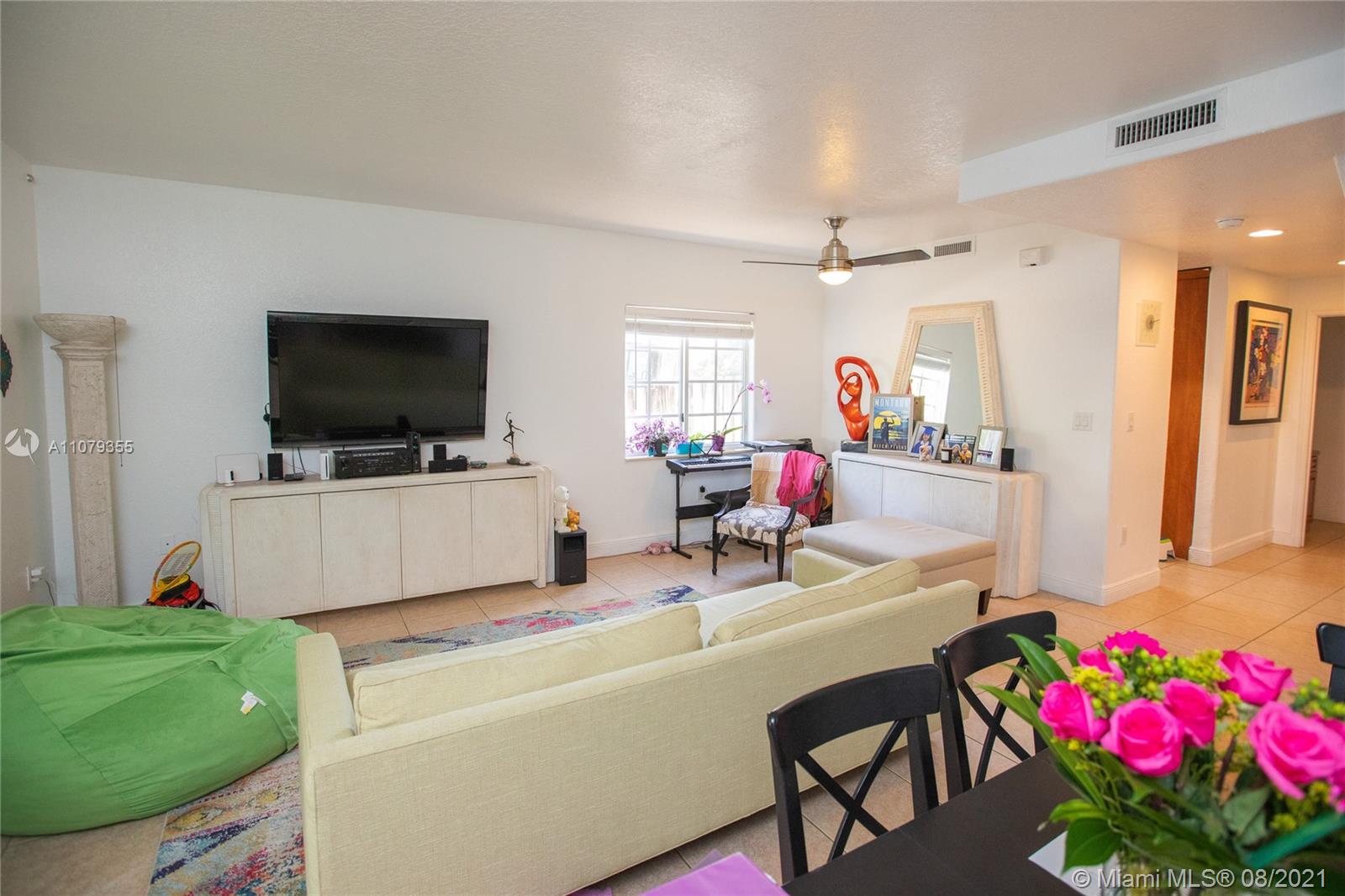 3053 Elizabeth Street, Unit 3053 Miami, FL 33133 - Photo 13 of 42 a living room with furniture and a flat screen tv