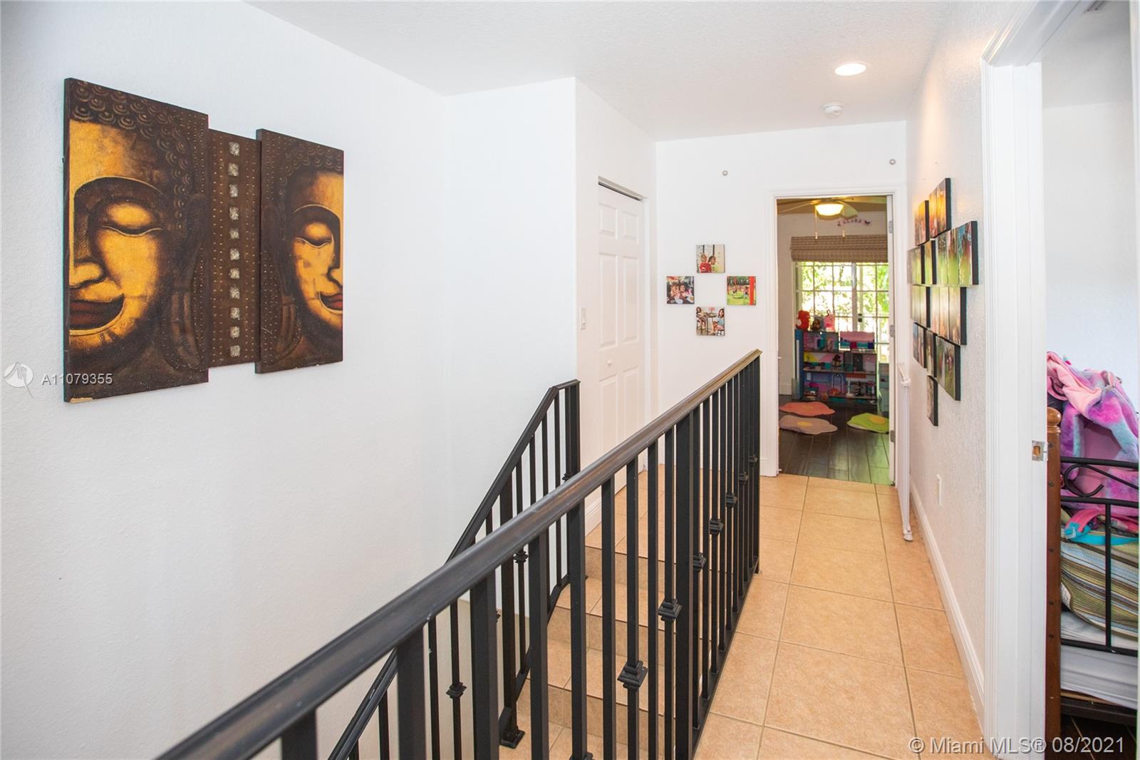 3053 Elizabeth Street, Unit 3053 Miami, FL 33133 - Photo 15 of 42 a view of a hallway with wooden floor and staircase
