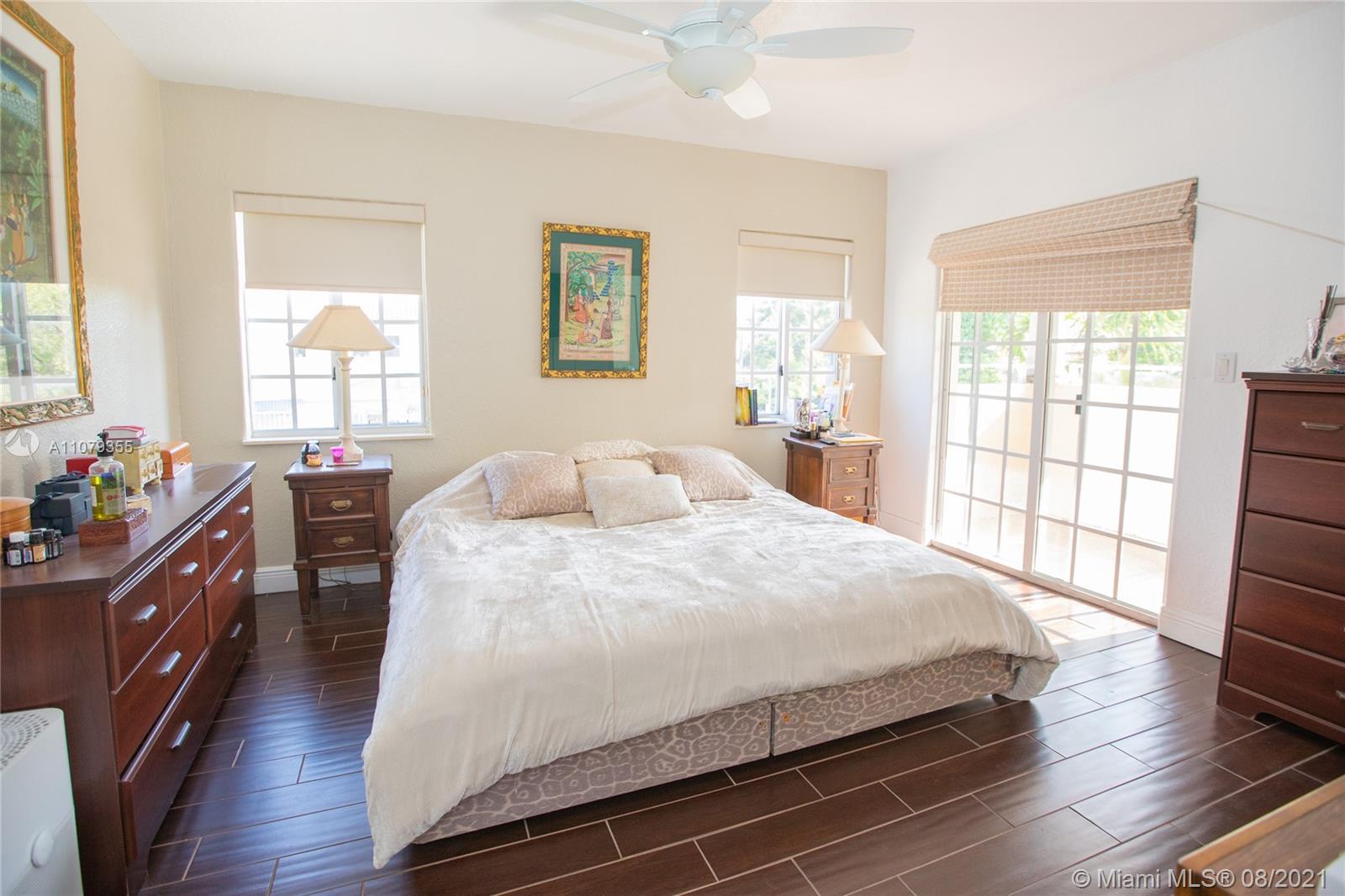3053 Elizabeth Street, Unit 3053 Miami, FL 33133 - Photo 17 of 42 a bedroom with a bed and wooden floor