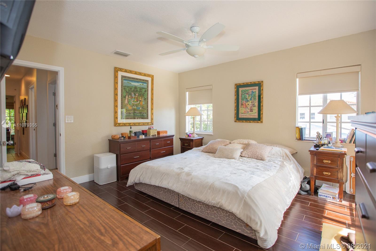 3053 Elizabeth Street, Unit 3053 Miami, FL 33133 - Photo 18 of 42 a bedroom with a bed and wooden floor